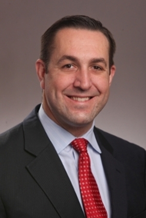Photograph of Richard Goins, executive male, brown hair and suit